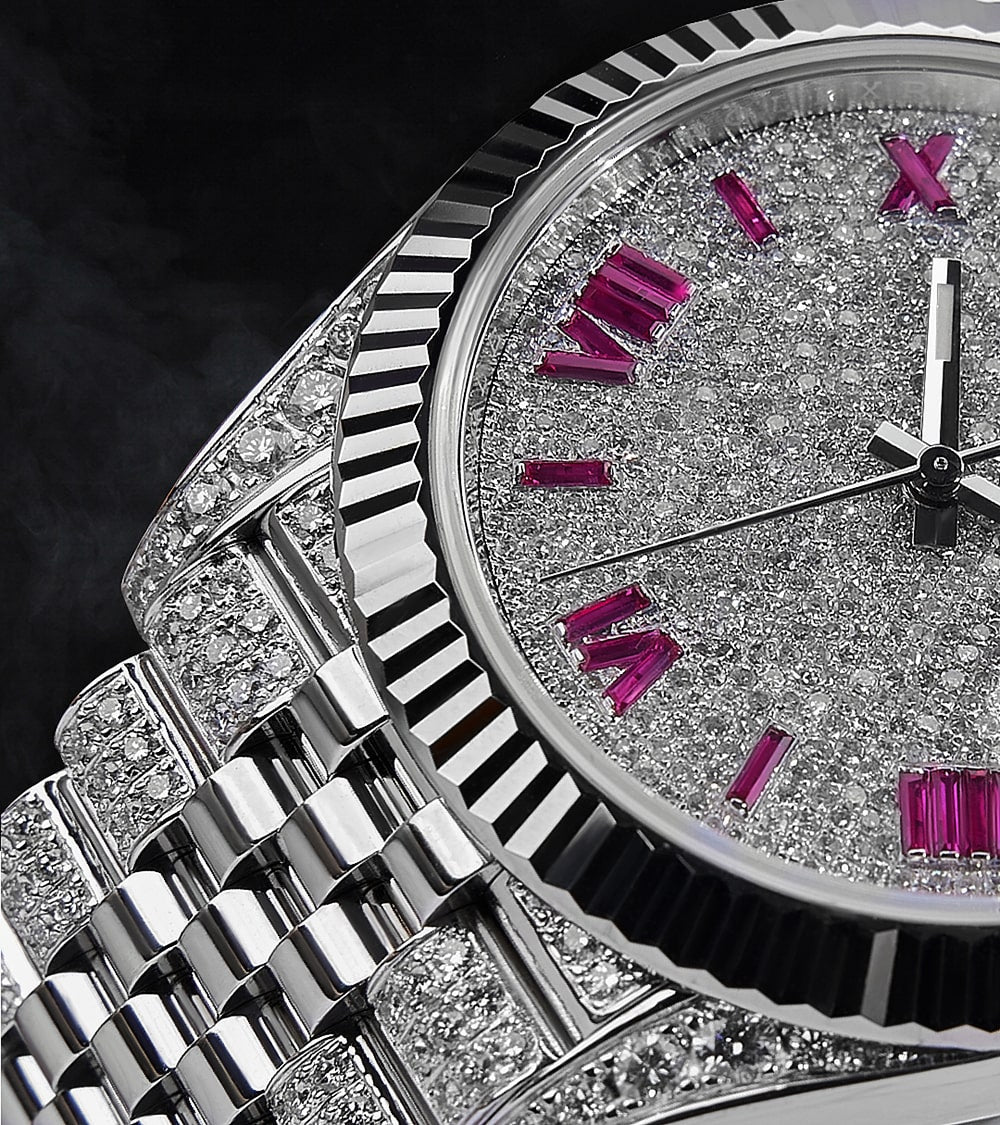 Image of a Rolex Datejust 41 with a custom diamond-set case and bracelet featuring a dial with ruby-colored Roman numeral markers by Cagau.