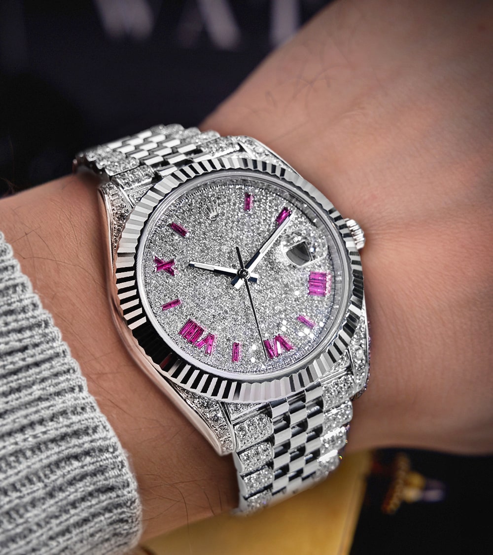 Image of a Rolex Datejust 41 with a custom diamond-set case and bracelet, featuring a dial with ruby-colored Roman numeral markers by Cagau.