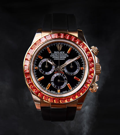 Image of a Rolex Daytona 40mm with a custom chronograph black dial and orange bezel by Cagau.