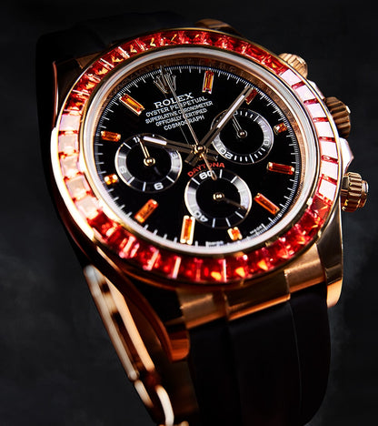 Image of a Rolex Daytona 40mm with a custom chronograph black dial and orange bezel by Cagau.