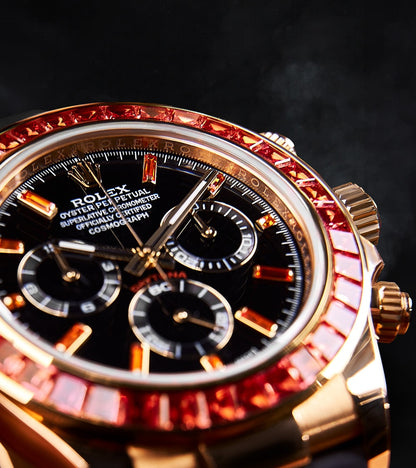 Image of a Rolex Daytona 40mm with a custom chronograph black dial and orange bezel by Cagau.