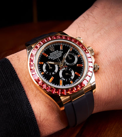 Image of a Rolex Daytona 40mm with a custom chronograph black dial and orange bezel by Cagau.