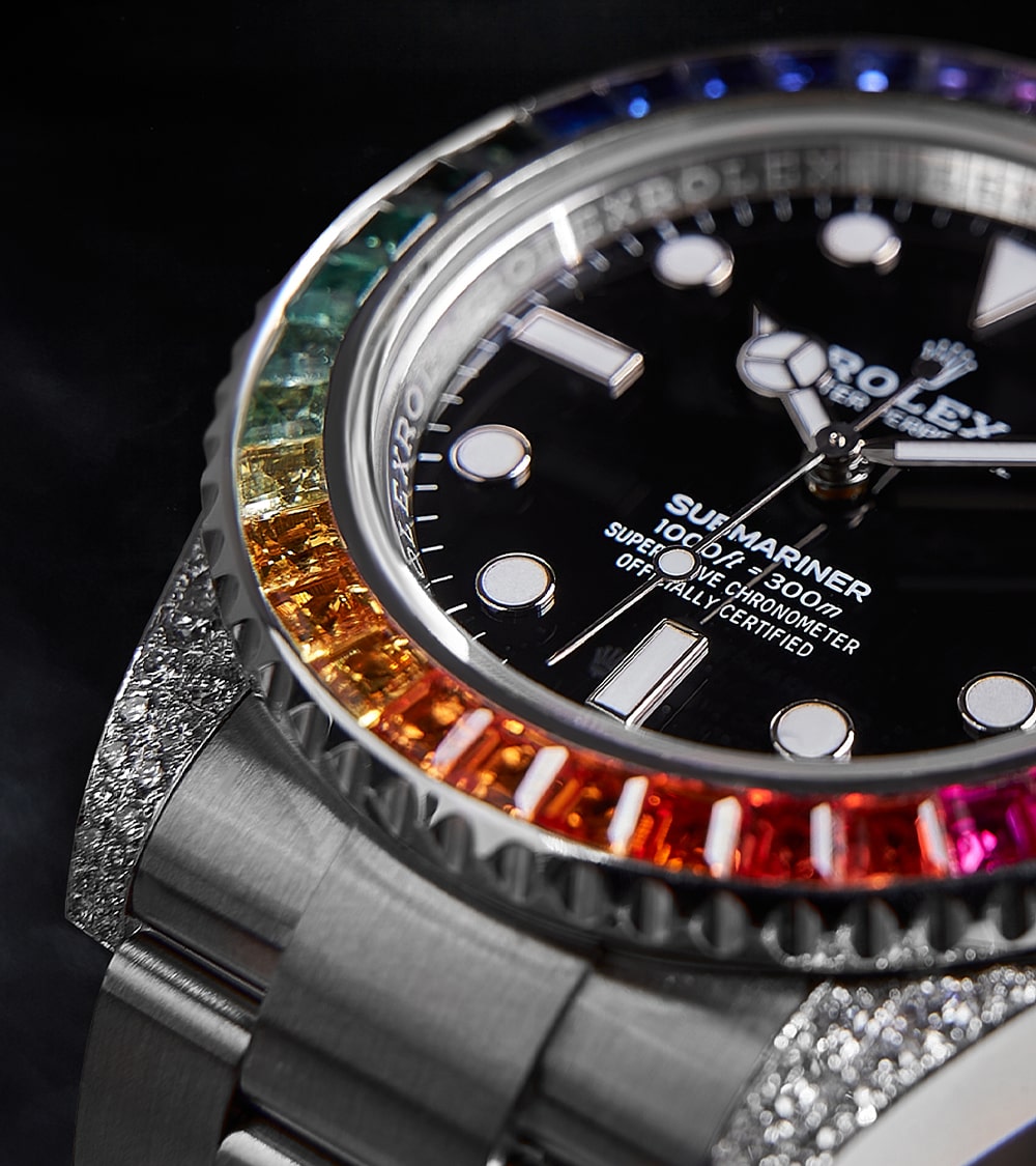 Image of a Rolex Submariner 41mm with a black dial and a custom rainbow bezel by Cagau.