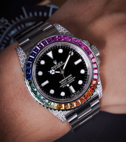 Image of a Rolex Submariner 41mm with a black dial and a custom rainbow bezel by Cagau.