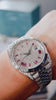 Video of a Rolex Datejust 41 with a custom diamond-set case and bracelet featuring a dial with ruby-colored Roman numeral markers by Cagau.